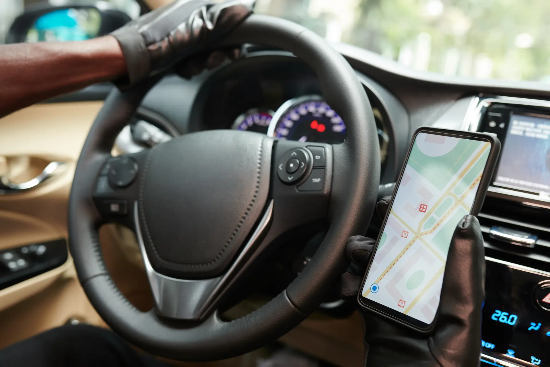 Driver using a smartphone navigation app inside a vehicle